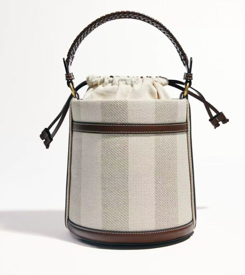 Brown Cylindrical Tote Bag With Dual Handles, Designed For Handheld Or Crossbody Wear