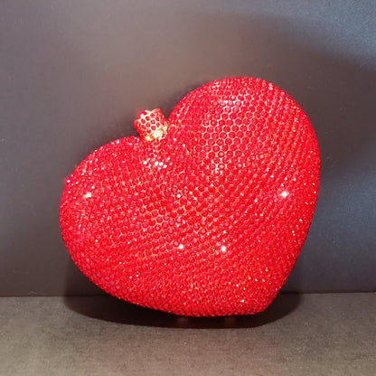 hand holding heart shaped diamond dinner bag