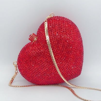 hand holding heart shaped diamond dinner bag