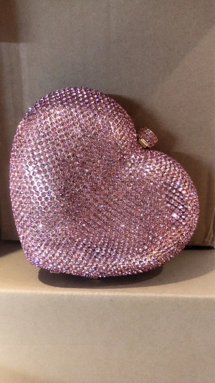 hand holding heart shaped diamond dinner bag