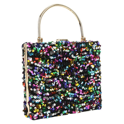 womens hand holding dinner bag colorful sequins