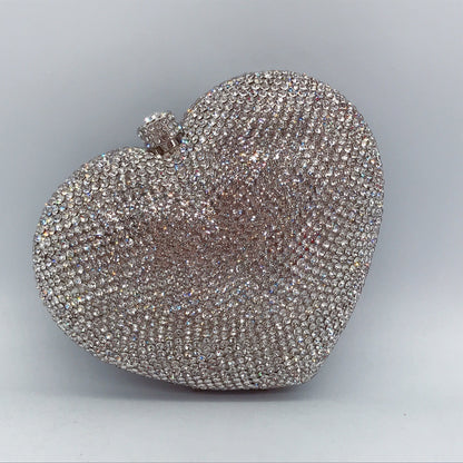 hand holding heart shaped diamond dinner bag