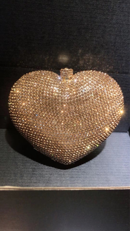 hand holding heart shaped diamond dinner bag