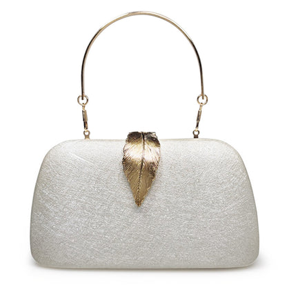 female minimalist dinner party with small square bag in hand