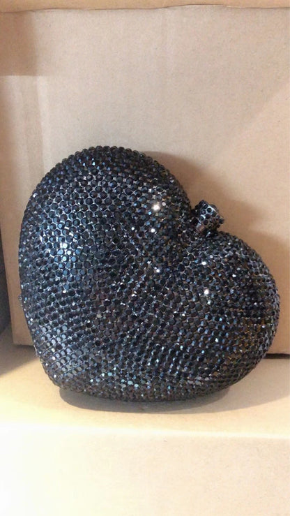 hand holding heart shaped diamond dinner bag