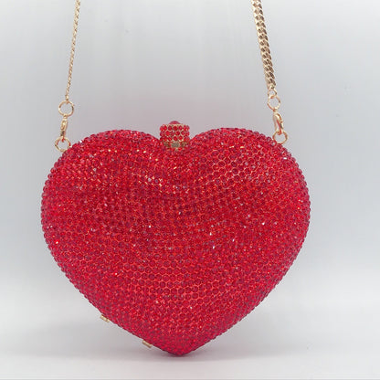 hand holding heart shaped diamond dinner bag